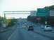 1995 Ford C-350 (Centurion Conversions) - Traffic moves along a highway with signs indicating an upcoming exit for the Atlanta Bypass.