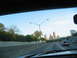 1995 Ford C-350 (Centurion Conversions) - View from a vehicle driving on a highway with a city skyline in the distance.