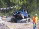 1989 Ford Bronco - A blue Jeep navigates a challenging obstacle course with concrete pipes.