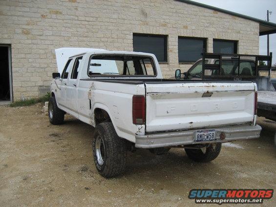 White Ford pickup truck, rear view, with a license plate reading 8MD-W58