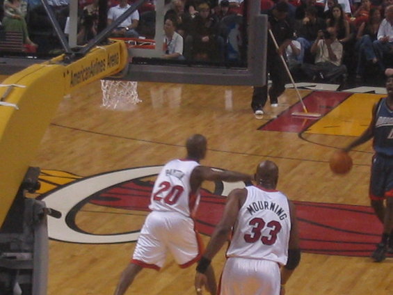 Basketball players on court, one wearing #20, another #33. American Airlines Arena visible