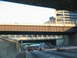 1995 Ford C-350 (Centurion Conversions) - Driving on a multi-lane highway with traffic and elevated structures.