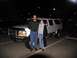1995 Ford C-350 (Centurion Conversions) - Two people pose with a 1995 Ford C-350 (Centurion Conversions) in a parking lot at night.