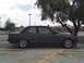 1989 BMW 3 Series - A gray BMW 3 Series coupe is parked under a tree in a parking lot.