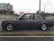 1989 BMW 3 Series - Side view of a dark gray coupe with distinctive wheels, parked in a lot.
