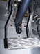 1969 Ford Bronco - Close-up view of the brake pedal assembly, showing the diamond plate footrest and associated linkage.