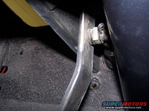 Close-up of a brake line connection with a nut and clip