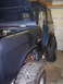 1969 Ford Bronco - A dark blue Ford Bronco is shown with its hood up, revealing the engine bay and front fender area.