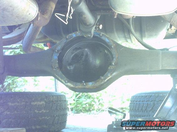 Rear differential assembly with exposed gears, supported by jack stands and tires