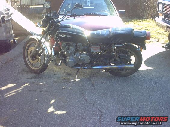 1979 Suzuki GS550 motorcycle parked in front of a car
