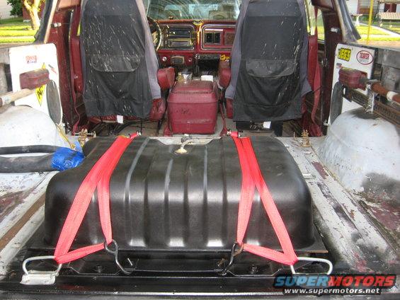 Interior view of a 1979 Ford Bronco with auxiliary fuel tank strapped in cargo area