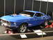 1969 Ford Mustang - 1969 Ford Mustang coupe on display, a hood scoop and custom wheels.