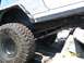 1989 Ford Bronco - This off-road vehicle is shown from the side, with its large tires and suspension system visible as it moves over rocks.