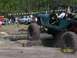 1989 Ford Bronco - Off-road vehicles tackle a log obstacle course during an event.