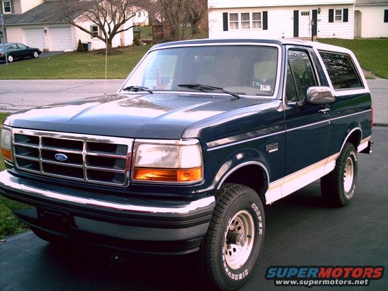 Dark blue 1993 Ford Bronco with white trim and a white roof