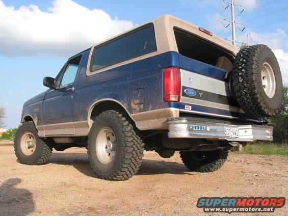 1996 Ford Bronco SUV parked on dirt with spare tire mounted on rear door