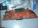 1974 Ford Bronco - This orange intake manifold features two carburetor openings and shows signs of rust and wear.
