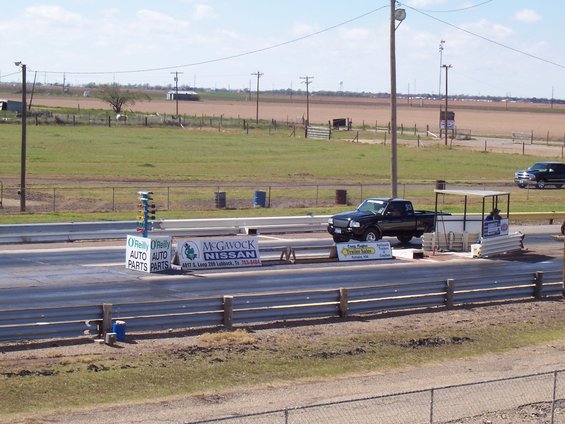 Black Ford Ranger pickup truck at drag strip starting line