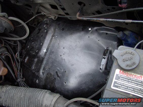 img_0372.jpg I re-drilled and relocated the plastic wiring harness loops further down the wheelhouse, away from the center, where the toolbox sits. Notice the washer fluid/coolant reservoir is relocated from the side to the front core support so a bigger toolbox can be fitted. 