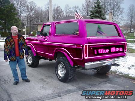 guy next to a shiny purple 1978 Ford Bronco with 'I like Men' on the tailgate