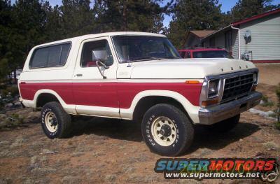 1978 Ford Bronco with white top and red lower body, parked outdoors