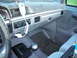 1995 Ford F-250 - The interior of this 1995 Ford F-250 features a manual transmission and a gray dashboard with a fuzzy cover.