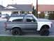1988 Ford Bronco - This lifted 1988 Ford Bronco features a two-tone paint scheme and a roof rack.