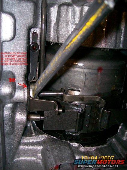 Close-up of transmission linkage with handwritten notes on the casing