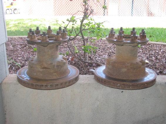 Two rusty Dana 60 front hubs with brake rotors