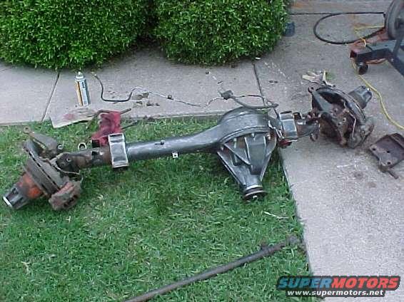 Ford Bronco rear axle assembly on grass and concrete, with brake components visible