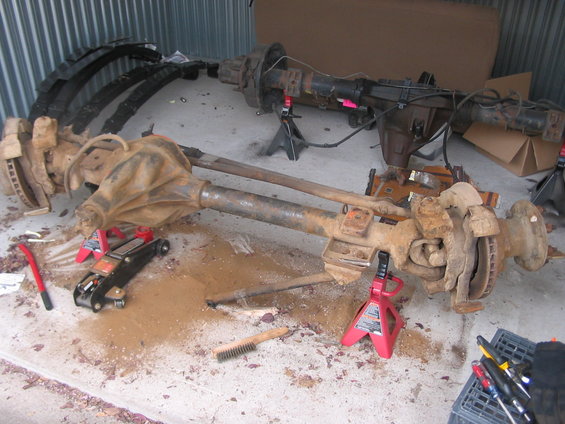 Dana 60 front axle assembly with leaf springs, jack, and jack stands