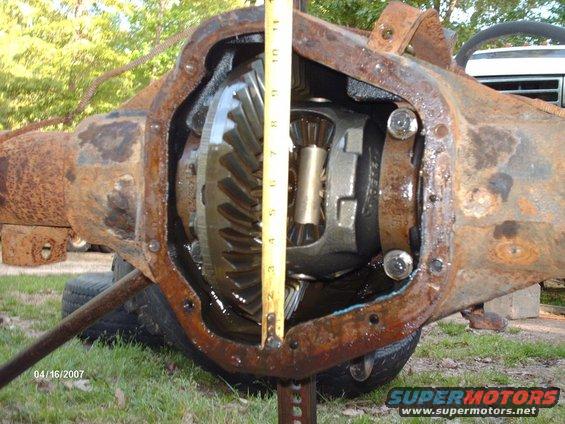 close-up of rusty differential housing with a tape measure inside
