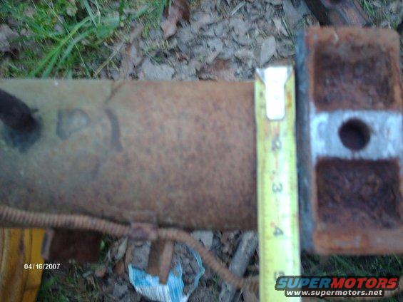 Rusty metal pipe measured with tape measure