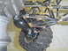1993 Ford Bronco - Close-up view of the suspension system and tire of a custom off-road vehicle.