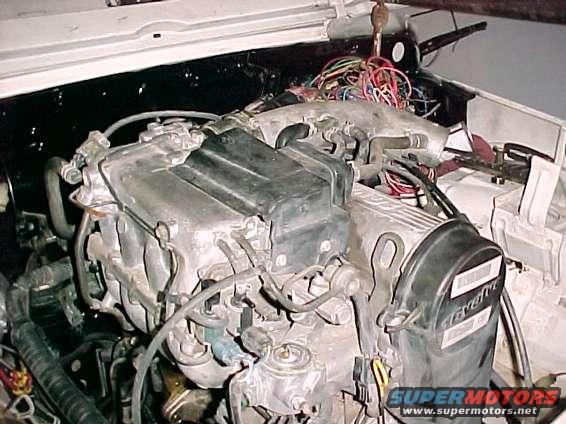 Engine bay with visible wiring and engine parts