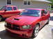 2006 Dodge Charger - Red 2006 Dodge Charger SRT8 with a red pickup truck in the background.