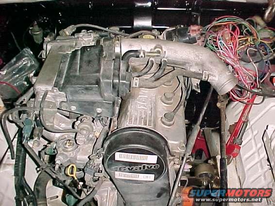 Engine bay with tangled wires and "16valve" label on intake