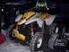 2001 Polaris TRAIL BLAZER - A Polaris Trail Blazer ATV is parked outside in the snow, with a trash can and a vehicle in the background.