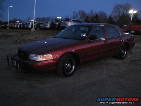 2001 Ford Crown Victoria sedan with push bumper parked outdoors at dusk