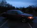 2001 Ford Crown Victoria - A dark red 2001 Ford Crown Victoria sedan is parked outside at dusk, equipped with a push bumper.