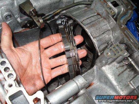 Hand holding transmission clutch pack plates during rebuild