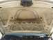 2000 Ford Crown Victoria - The underside of a car hood is visible, showing structural bracing and signs of wear and tear.
