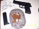 2000 Nissan Xterra - A pistol and magazine are shown next to a target with numerous bullet impacts.
