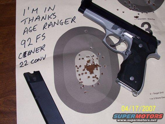 Beretta 92 FS pistol with magazine on a target with bullet holes. Text reads 'I'M IN THANKS AGE RANGER 92 FS CHEENER 22 CONV'. Date 04/17/2007 and SUPERMOTORS.NET logo visible
