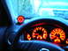 1994 Ford Probe - The interior of a car shows illuminated dashboard gauges and an aftermarket gauge mounted on the dashboard.