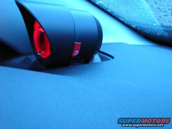 Interior car part with red light and a small red label