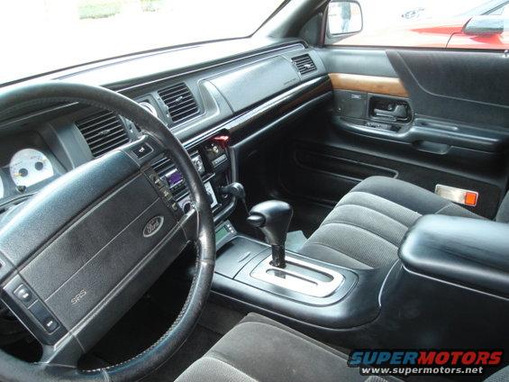 1992 Ford Crown Victoria interior with gray cloth seats, black dashboard, and wood trim