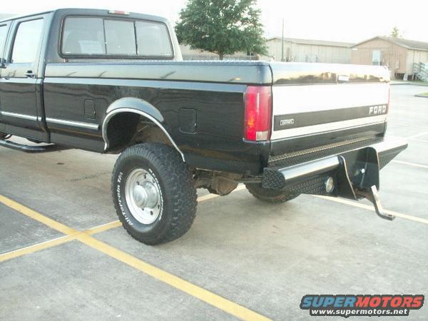 Black 1997 Ford F-350 rear quarter with custom bumper