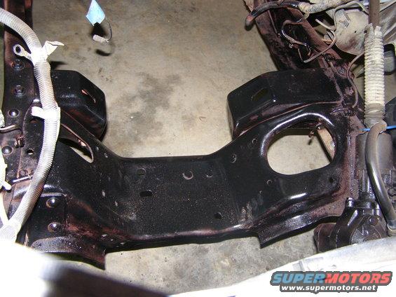 Close-up of a vehicle's frame and suspension parts, possibly from a Ford Bronco