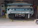 1992 Ford Mustang - The rear of a 1992 Ford Mustang is visible, showing its spoiler and wide tires during a restoration project.